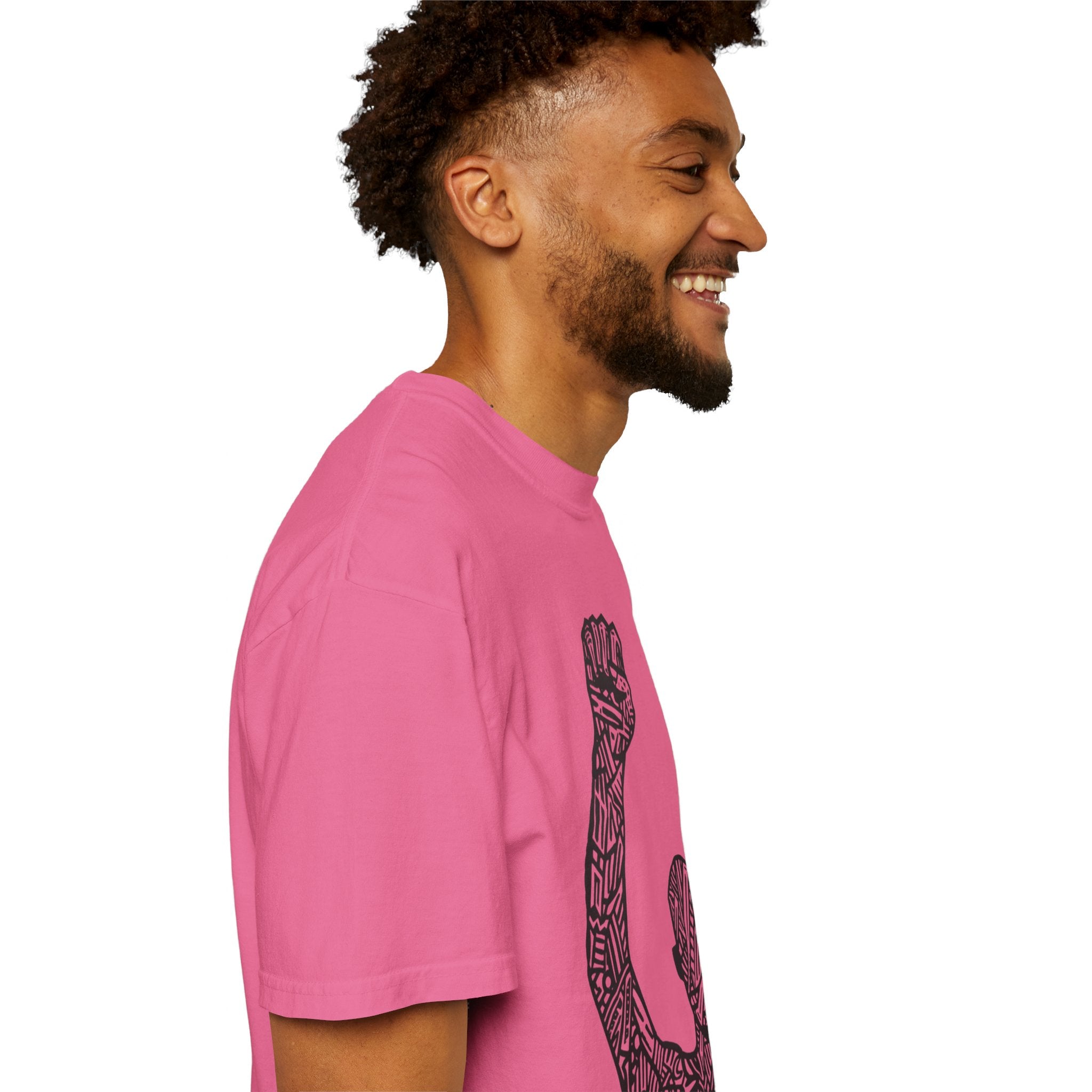 The image features a stylish unisex garment-dyed t-shirt in a rich, deep color. The front displays a striking silhouette of a raised fist, symbolizing strength and unity. The tee’s soft, comfortable fabric and relaxed fit are also highlighted, making it a blend of style, comfort, and meaning.