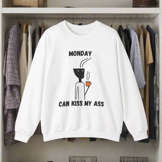 A unisex heavy blend crewneck sweatshirt with bold lettering reading "Monday Can Kiss My A...," offering a cozy fit and a stylishly rebellious vibe.