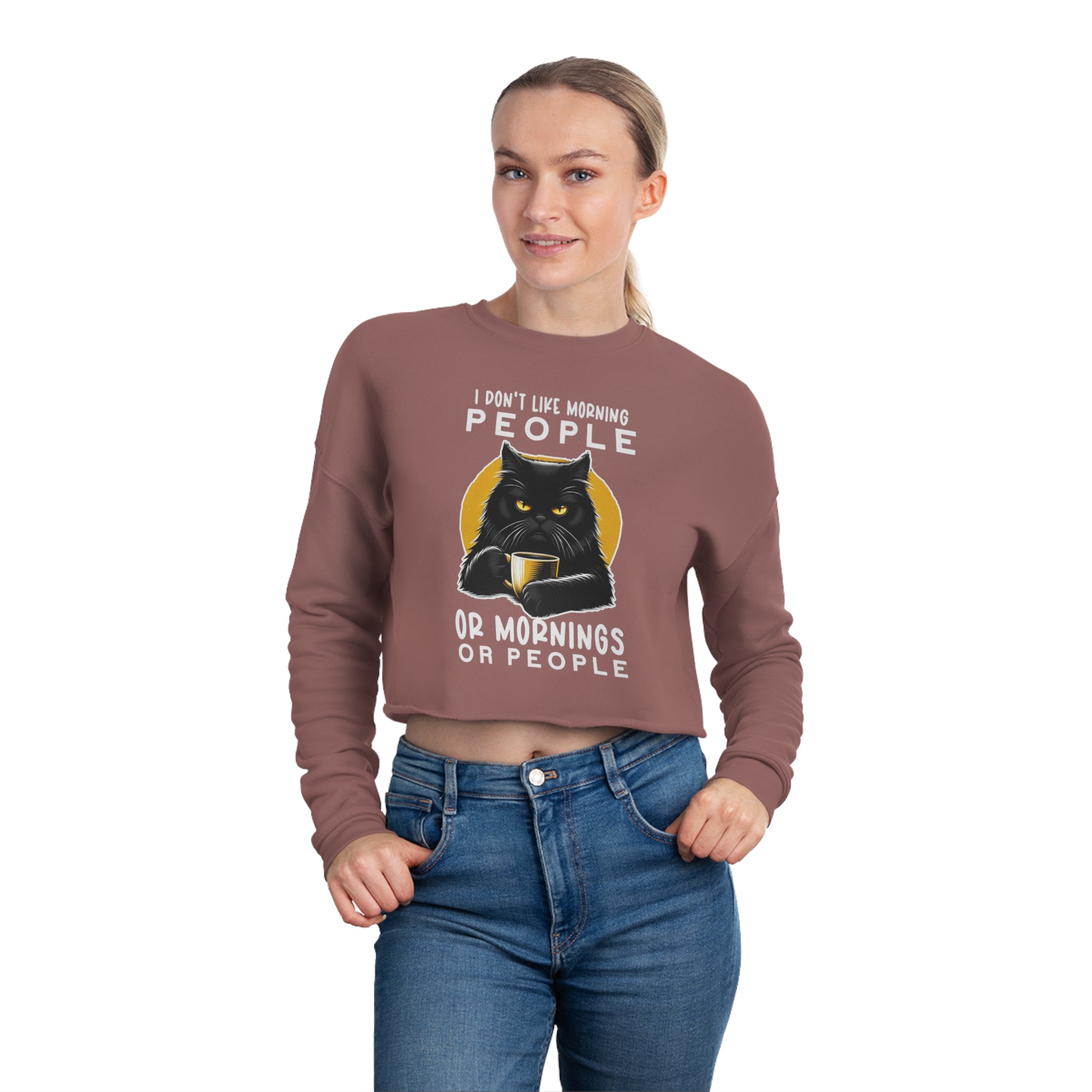 This image showcases a trendy women's cropped sweatshirt featuring the famous Grumpy Cat meme with the slogan “I Don't Like People...Grumpy Cat Coffee." The design emphasizes a playful yet relatable sentiment for those whose mornings must start with coffee. The sweatshirt's cropped style adds a fashionable edge, making it an ideal choice for those looking to combine comfort with a statement piece.