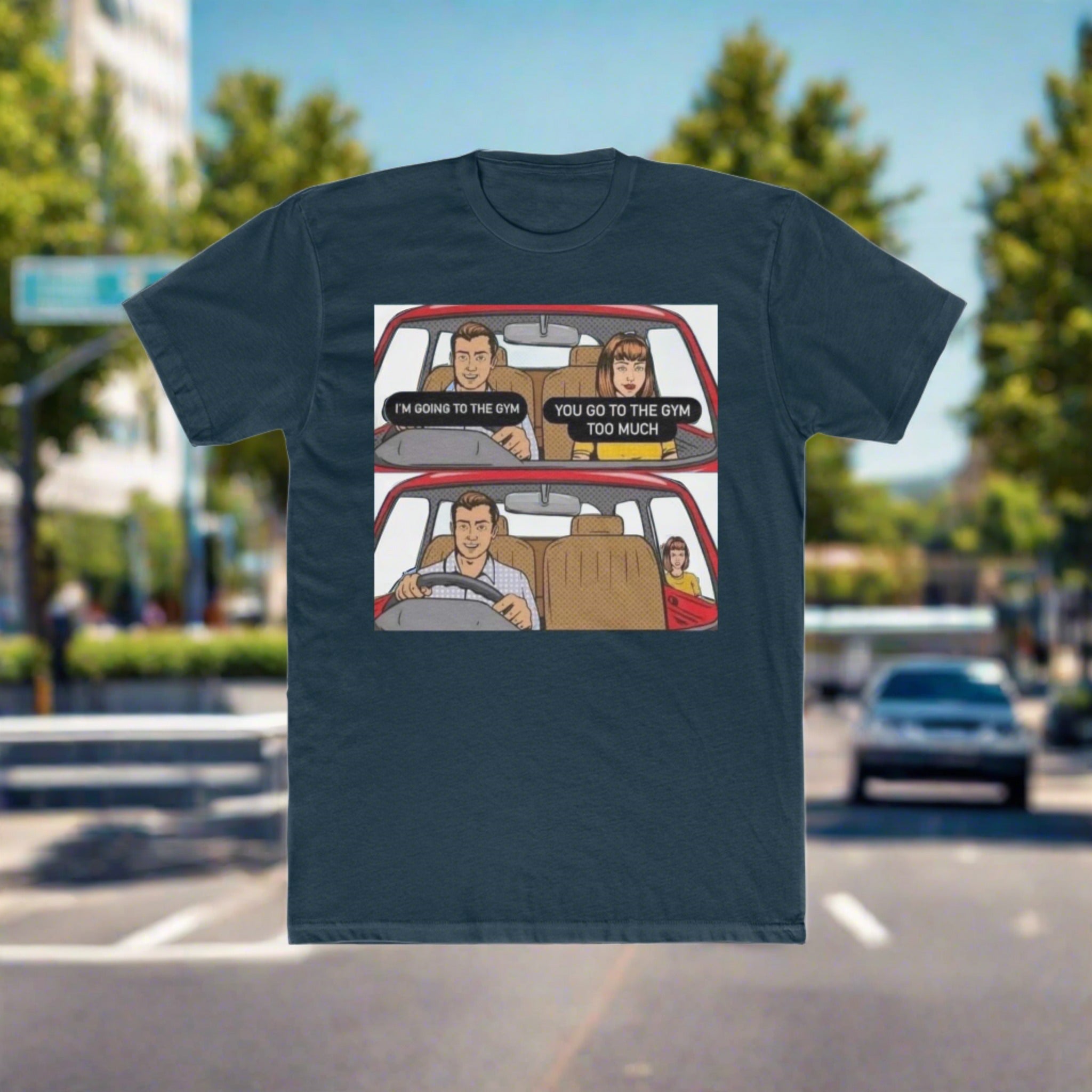 The image shows a stylish men's cotton crew tee adorned with a vibrant, comic-style illustration of a man humorously ejecting his girlfriend from the car on his way to the gym. The caption "Gym Over Romance" boldly underscores the image, making it clear where his priorities lie. The shirt's relaxed fit and soft material are evident, promising both comfort and style.