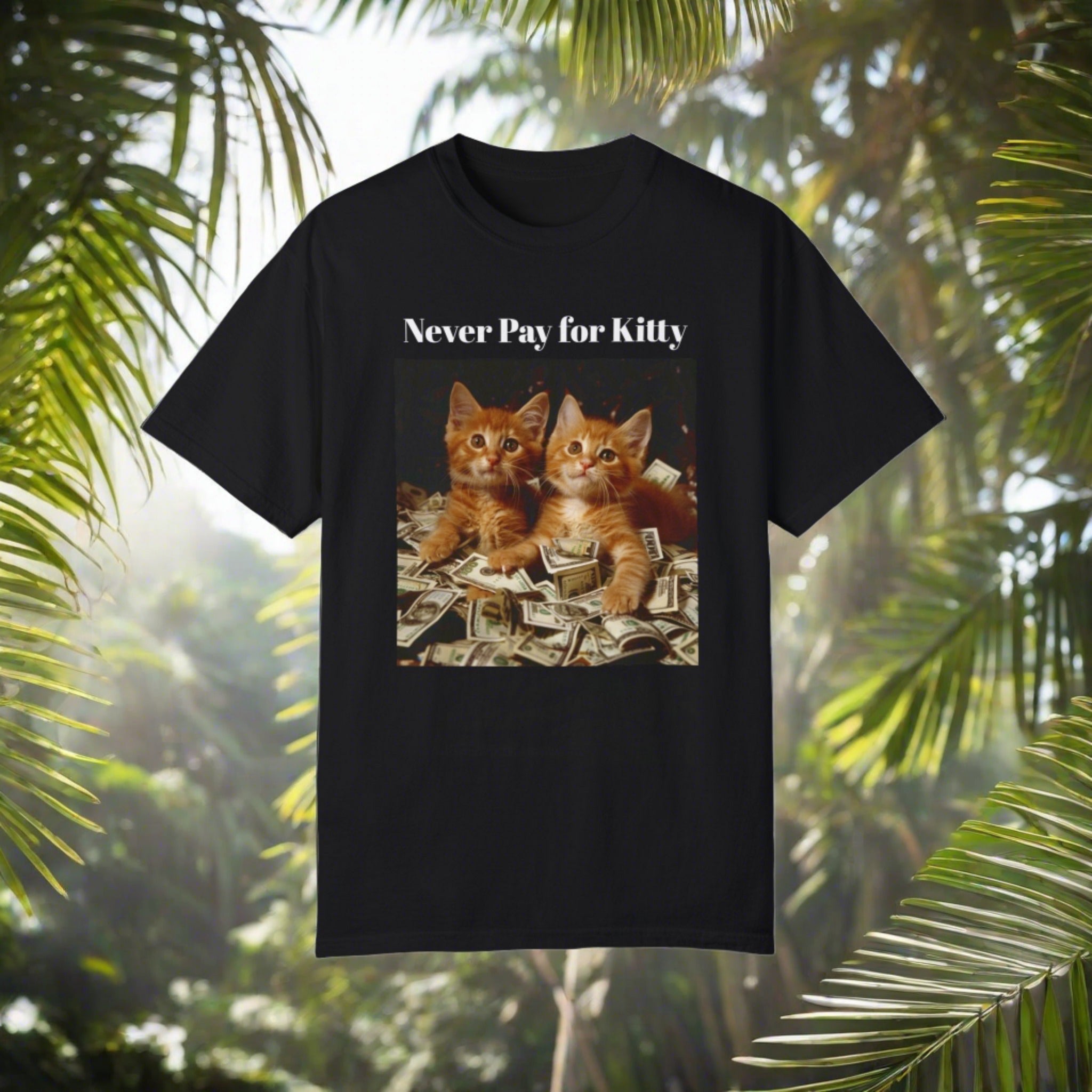 The image displays a unisex garment-dyed t-shirt in a chic, subdued color. The front graphic shows cute kittens frolicking in a pile of cash, beneath the bold caption "Never Pay for Kitty." The casual cut and vintage wash of the tee highlight its laid-back yet fashionable appeal, making it perfect for those who enjoy a pun with their fashion