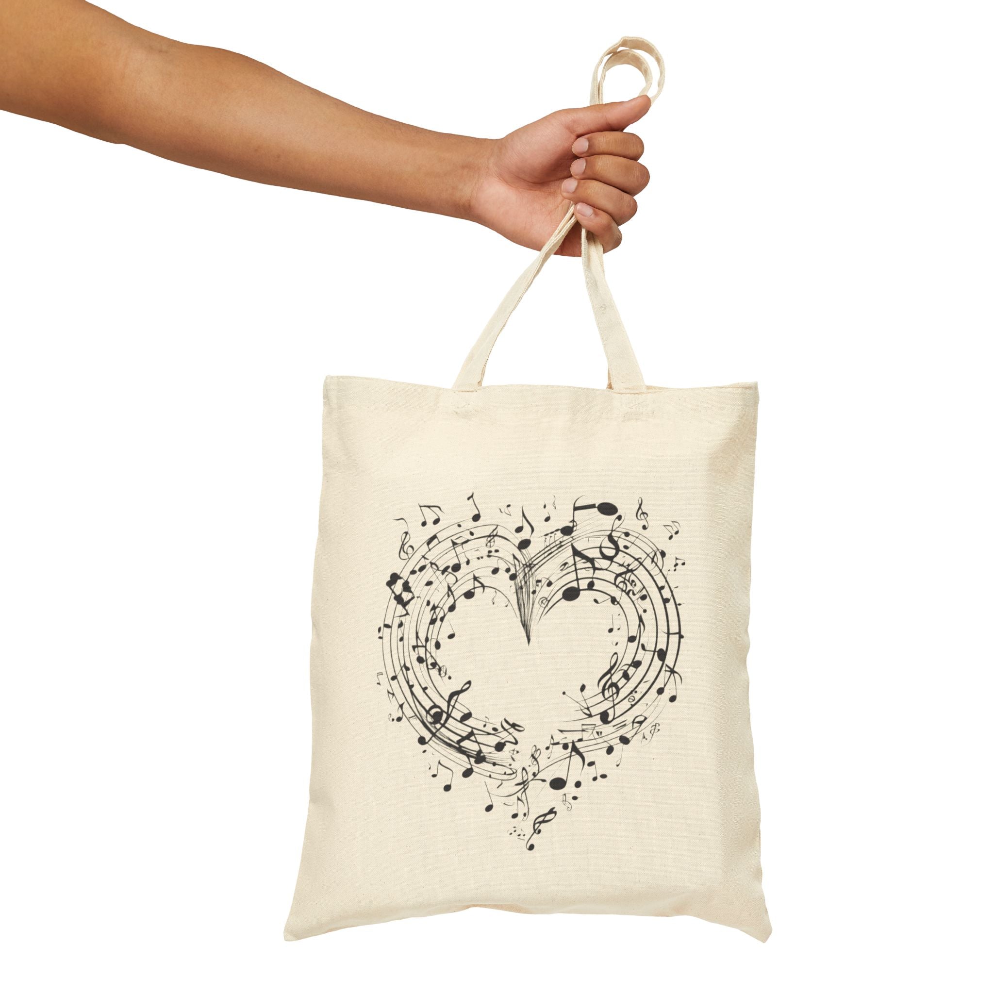 The image showcases a cotton canvas tote bag featuring a beautifully crafted musical heart design. The durable material and spacious interior are also highlighted, making it an ideal choice for everyday use.