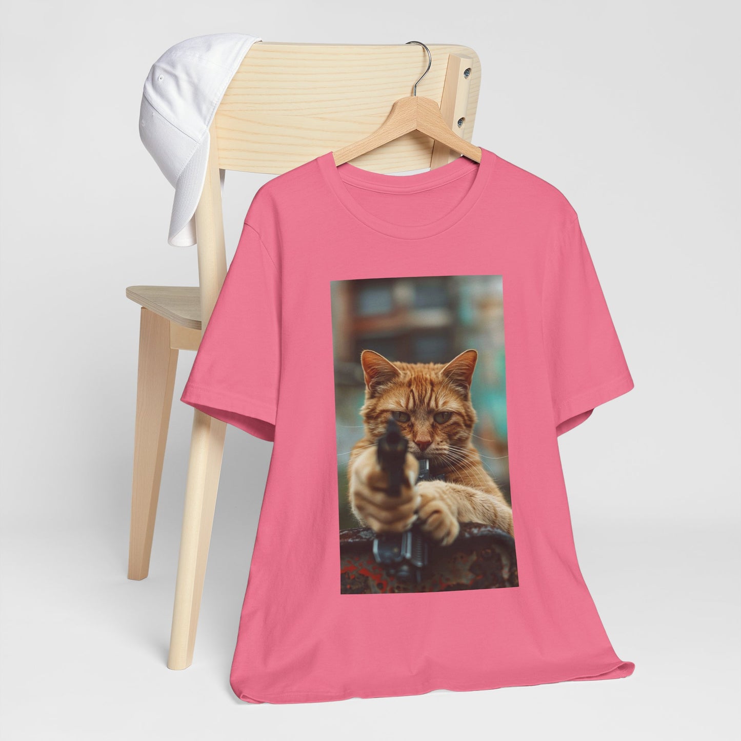 The image displays a sleek women's jersey short sleeve t-shirt, featuring a detailed and humorous image of a cat in role of hitman. The t-shirt is modeled to showcase its flattering fit and soft fabric, highlighting how fashion can meet fun and functionality