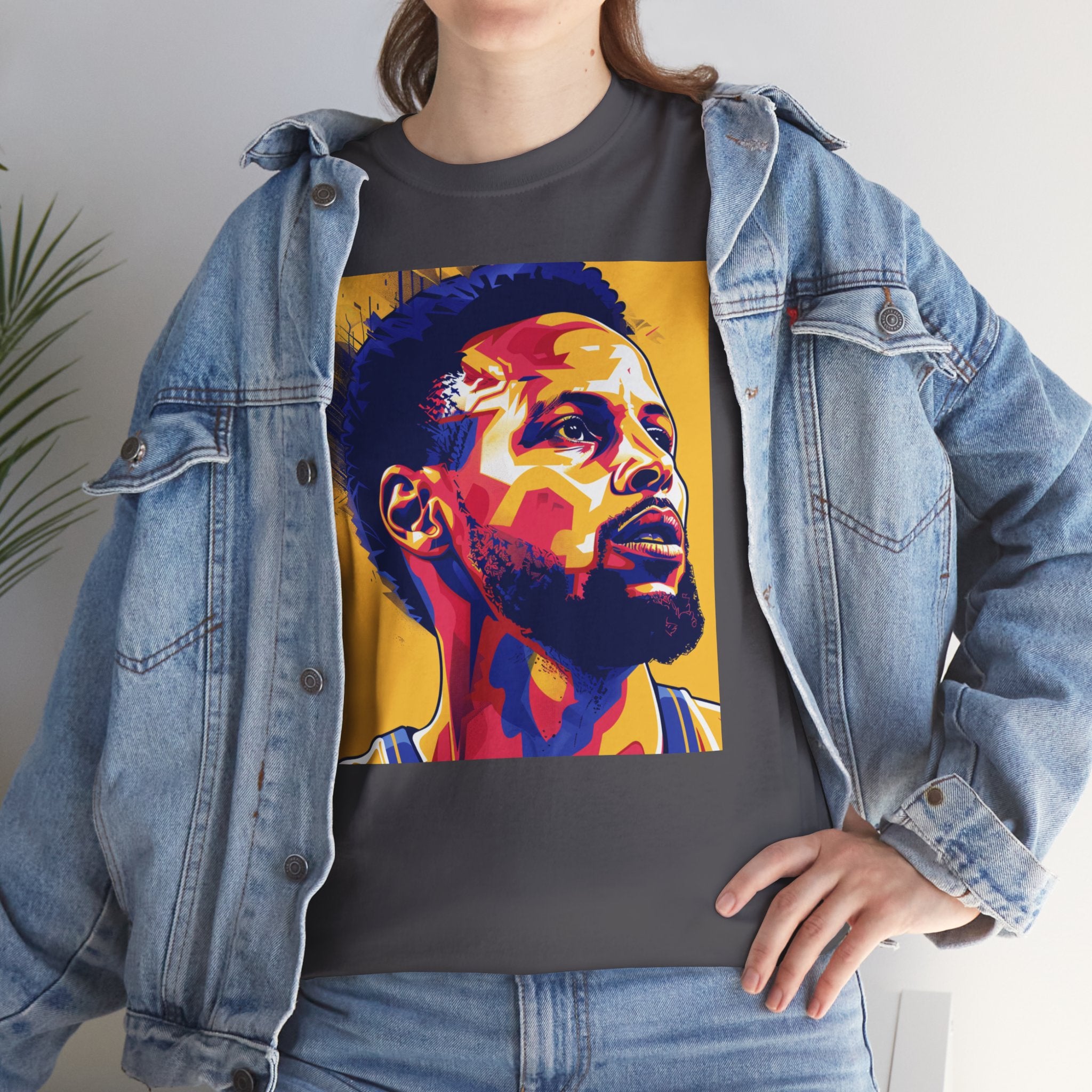The image showcases a high-quality unisex heavy cotton tee in a classic cut, featuring vibrant graphics that pay homage to the legendary 3-point shooter, Steph. The design captures the excitement and precision of his game, making it an essential addition to any basketball fan's wardrobe