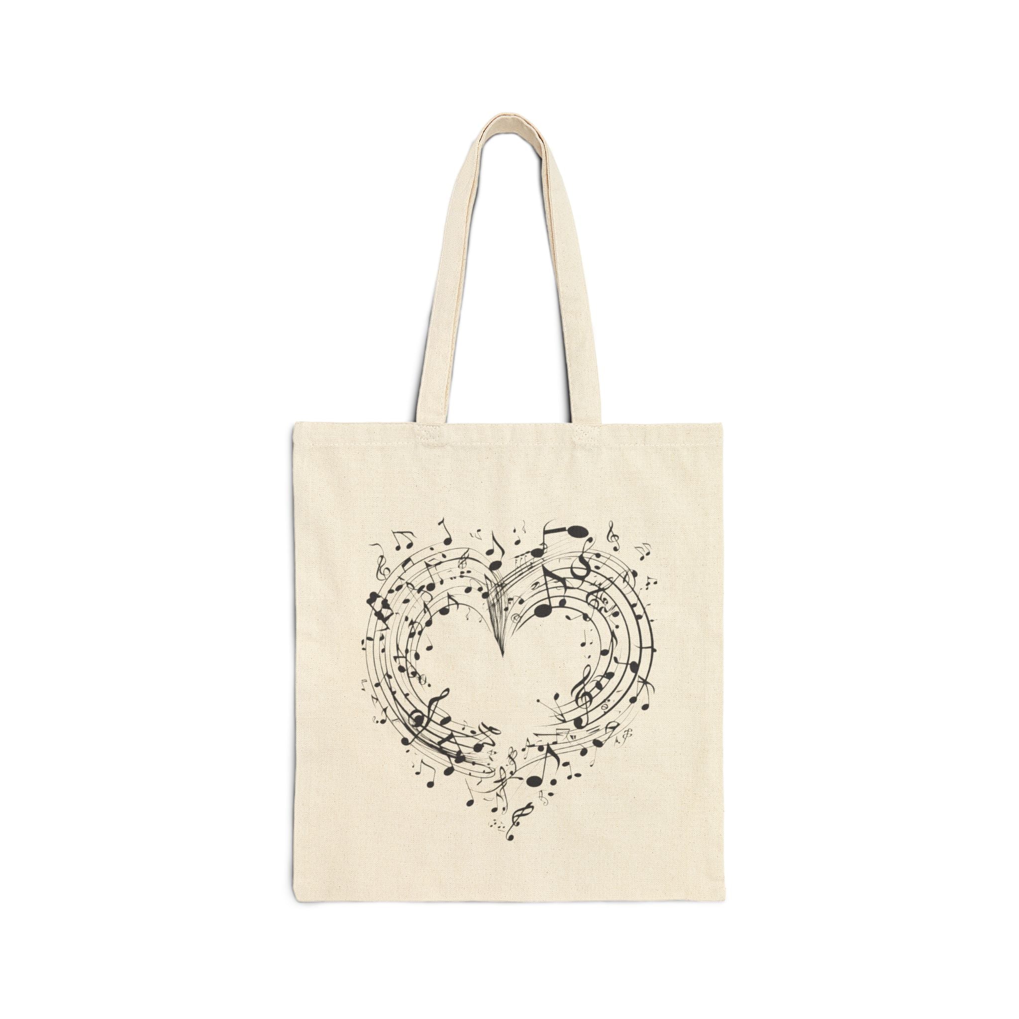 The image showcases a cotton canvas tote bag featuring a beautifully crafted musical heart design. The durable material and spacious interior are also highlighted, making it an ideal choice for everyday use.