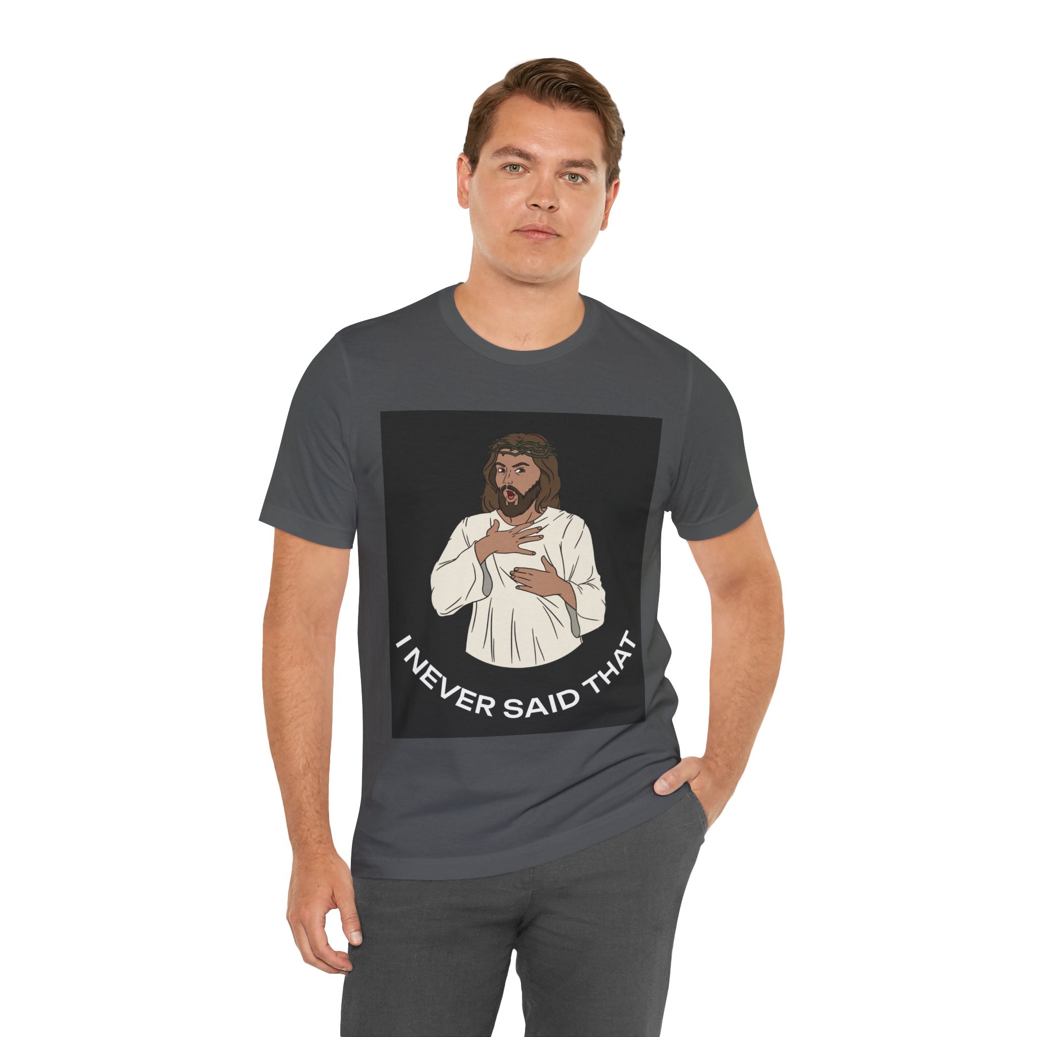 The image displays a stylish unisex jersey tee featuring the phrase "I Never Said That..." in bold, eye-catching letters, attributed humorously to Jesus. The shirt's quality and comfort are apparent, making it an appealing choice for those looking to express their faith with a touch of levity